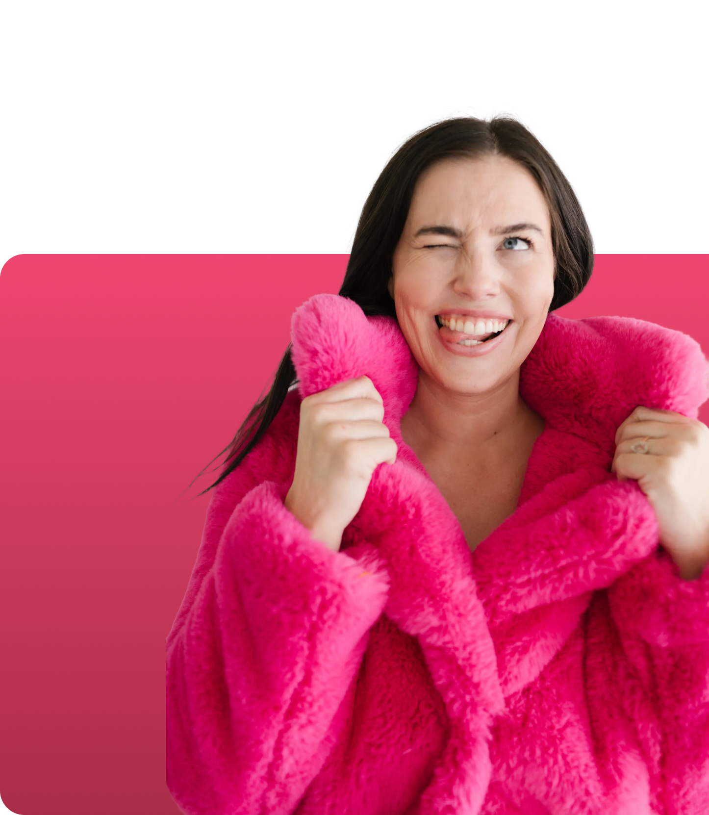 woman in furry pink coat winking